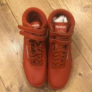 Reebok Freestyle Hi sneaker. Dual hook and loop straps and puffy collar. NWOT